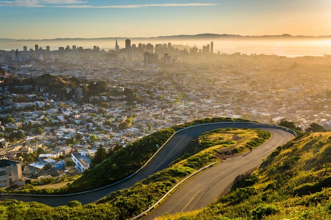 Curvy road and view of downtown at sunrise from Twin Peaks, in San Francisco, California..jpeg
