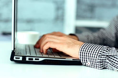 Closeup image of a male hands typing on laptop keyboard.jpeg